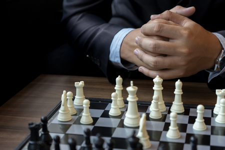 Businessman thinking how to play chess concept business strategy for winの写真素材