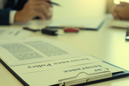 Yound Business man insurance agent and customer look at the contract together at the table in office vintage tone の写真素材