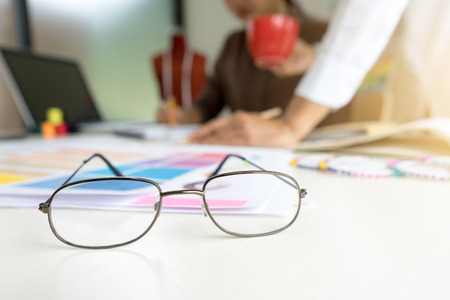 focus on eyeglass fashion designer work in the studio with graphic and tailor tool on the tableの写真素材