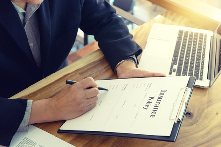 Young Business man insurance agent show document contract to the customer at the table in officeの写真素材