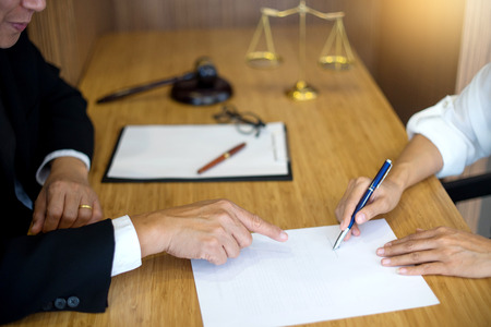Judge gavel with Justice lawyers having meeting with team  at law firm in background. Concepts of...