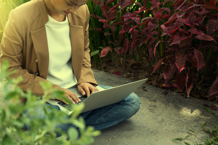 businesswoman do business use computer out of the office in the garden green and fresh airの写真素材