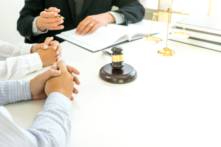 Judge gavel with Justice lawyers having team meeting at law firm in background. Concepts of law or Auction. の写真素材