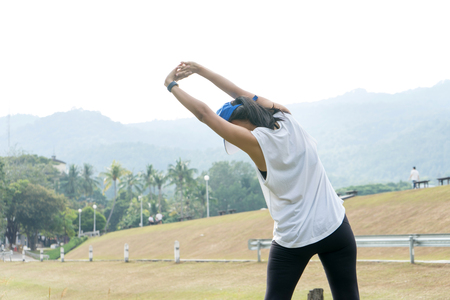 young woman warm up  stretching exercise  in the park for her sport outdoorの写真素材