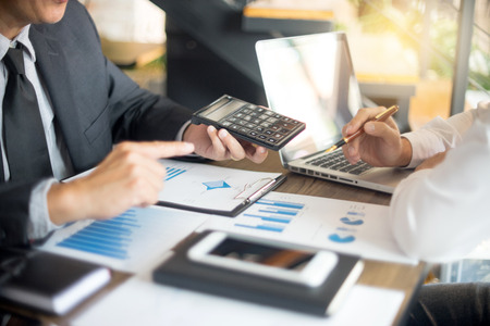 Businessman work with computer on table in office work with paper graph chart business marketing plan analysis の写真素材