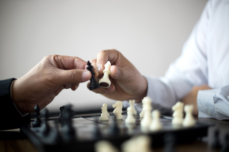 Businessman thinking how to play chess concept business strategy for winの写真素材