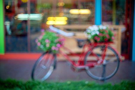 Blur front shop from the road view show window and bokeh with bicycle flowerの写真素材