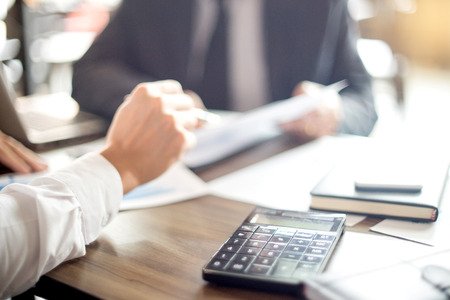 Businessman work with computer on table in office work with paper graph chart business marketing plan analysisの写真素材