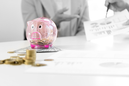 Business man woman hold collect coin in the row in front of the saving box concept economy investment  mix color black and whiteの写真素材