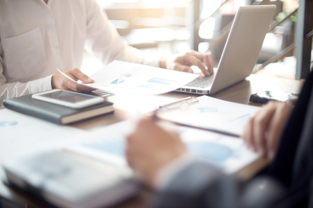 Businessman work with computer on table in office work with paper graph chart business marketing plan analysisの写真素材