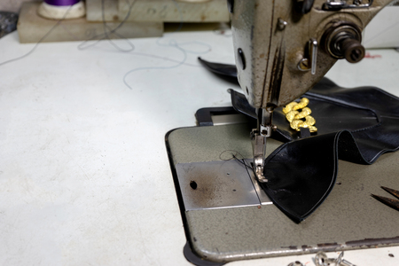 shoe maker work place with sewing leather color thread