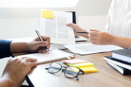woman and man work for education or business on the table with notebook laptop and paper work color penの写真素材
