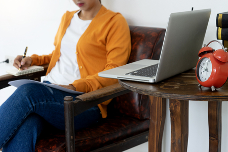 woman work at home with her computer and paper note use internet in the room working online style.の写真素材