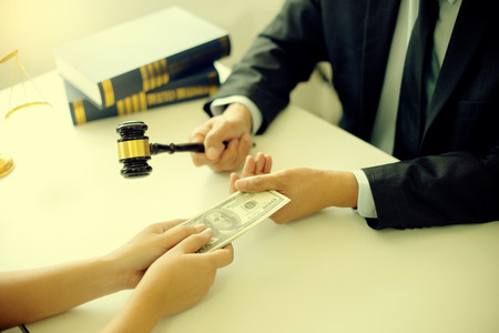 Judge lawyer gavel with bribe money in law firm concept corruptionの写真素材