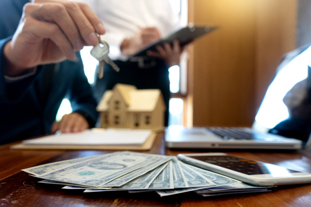 Sale man for house broker show and give home key to the customer ,buy from agentの写真素材