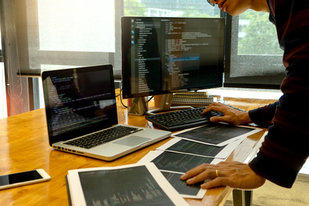 programmer work with Developing programming and coding technologies.  Programmer working with software on  many computer on the table in office. concept Website designの写真素材