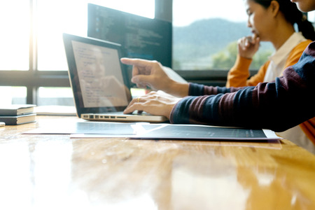 programmer work with Developing programming and coding technologies.  Programmer working with software on  many computer on the table in office. concept Website designの写真素材