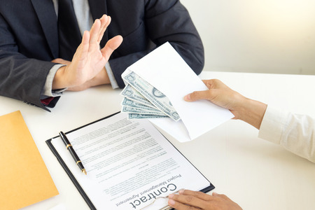 Business man give bribe to the officer but officer say no concept corruptionの写真素材