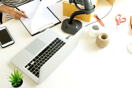 ecommerce concept, in office or home working prepare product in the box for send to customer who...