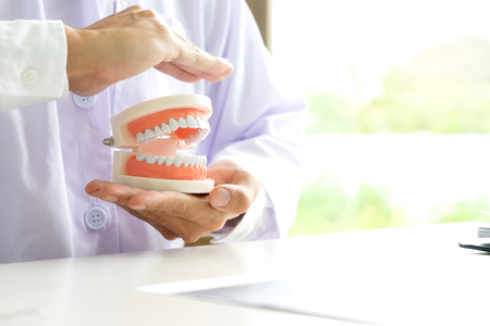 dentist work on the table with Denture and teeth x-ray paper for mouth healthの写真素材