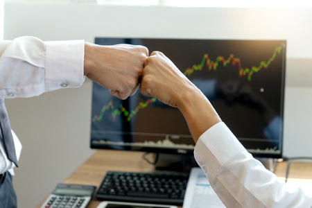 two business man use hand to fist bump for succes teamwork coporate  , white tablet screen with  clipping pathの写真素材
