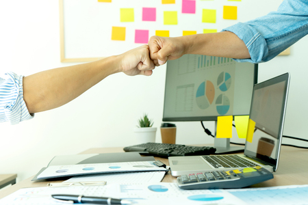 two business man use hand to fist bump for succes teamwork coporate  , white tablet screen with  clipping pathの写真素材