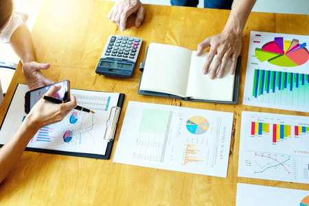 business businessman and woman in meeting analyses chart graphy marketing plan in business projectの写真素材