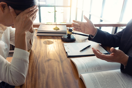 Judge or lawyer talking  with client who feel sad about consult law detail, law firm concept.の写真素材
