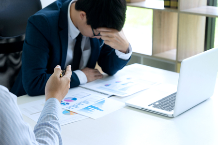 businessmans sit quarrel at the table fill sad and headache , concept business failure or problemの写真素材