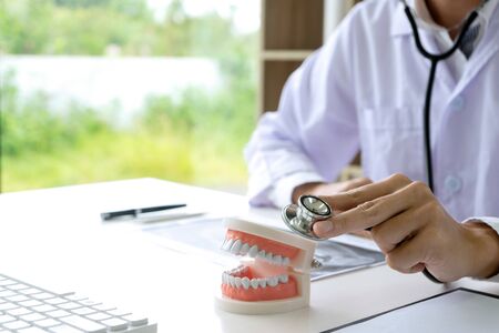dentist work on the table with Denture and teeth x-ray paper for mouth health