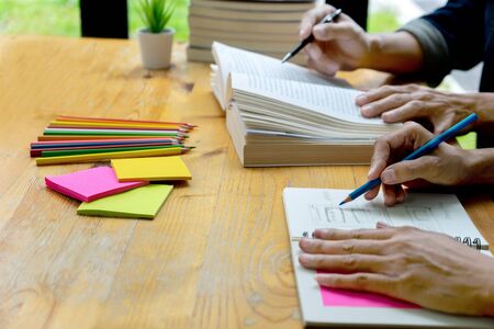 woman and man work on the table with notebook laptop paper work  and color pen, in concept of...