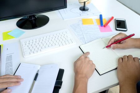 woman and man work for education or business on the table with notebook laptop and paper work color penの写真素材