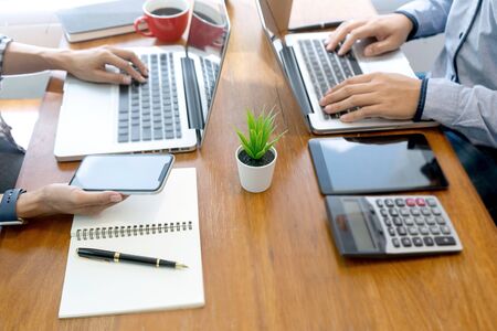 in office businessman business  work with friend on the table with computer laptop calulator ,working marketing plan data analyses.の写真素材