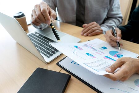 In office businessman in meeting analyses chart graphy marketing plan in business financial  audit project. Or Business adviser analyzing Budget,の写真素材