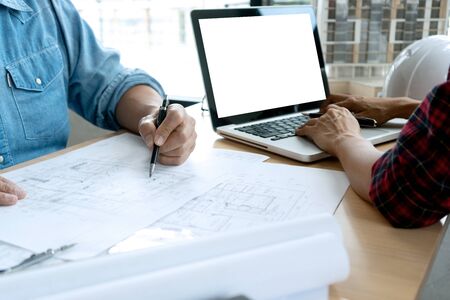 engineer or architectural project, two engineering or architect discussing and working on blueprint...