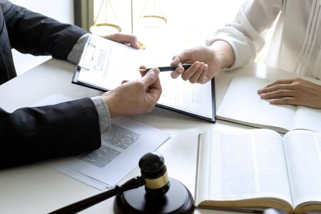 Judge or lawyer talking  with team or client about consult law detail and prepare to sign contract agreement, law firm concept.の写真素材