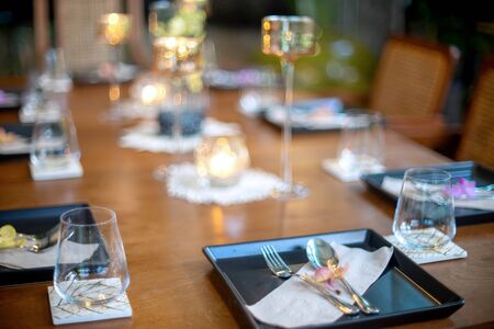 Dinner set on the wood table with long wine glass ware.の写真素材