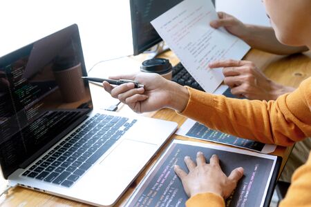 programmer work with Developing programming and coding technologies.  Programmer working with software on  many computer on the table in office. concept Website designの写真素材