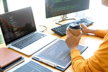 programmer work with Developing programming and coding technologies.  Programmer working with software on  many computer on the table in office. concept Website designの写真素材