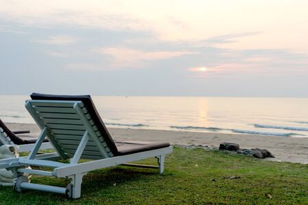 Chair bed on sand beach, early in the morning when sun rise time.の写真素材