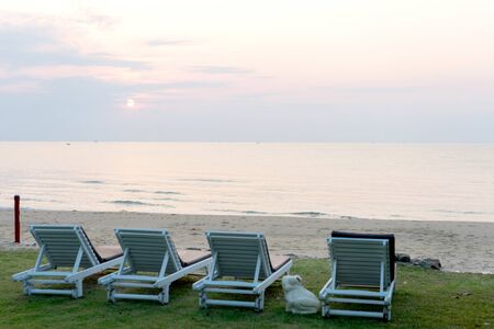 Chair bed on sand beach, early in the morning when sun rise time.の写真素材