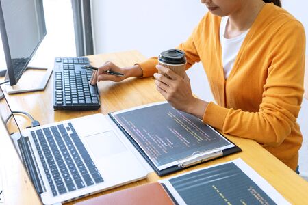 programmer work with Developing programming and coding technologies.  Programmer working with software on  many computer on the table in office. concept Website designの写真素材