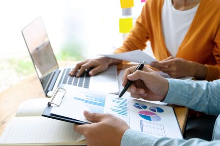 Young businessman creative meeting in the office working with graph and chart on the tableの写真素材