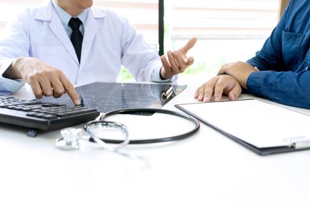 in hospital professional brain doctor give a counselor to the patient and tell the detail to help for good health, Stethoscope Medical instruments are on the tableの写真素材