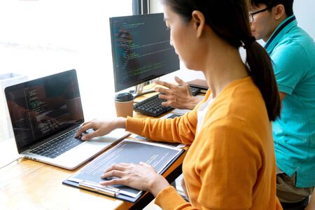 programmer work with Developing programming and coding technologies.  Programmer working with software on  many computer on the table in office. concept Website designの写真素材