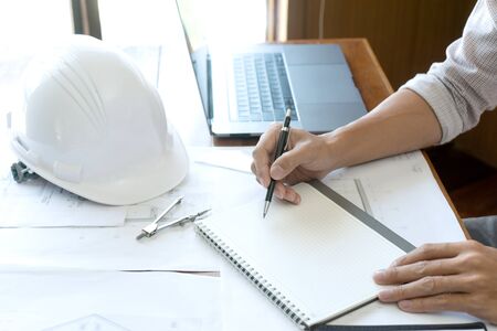 Group of engineering or architect discussing and working on blueprint with architect equipment,...
