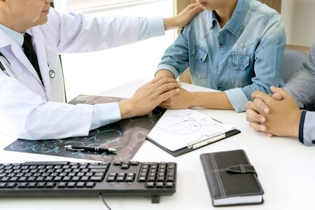 in hospital  professional brain doctor give a counselor to the patient and tell the detail to help for good health, Stethoscope Medical instruments are on the tableの写真素材