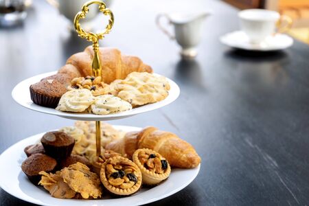 High tea set are on the black table be outdoor.の写真素材