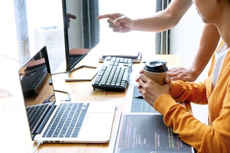 programmer work with Developing programming and coding technologies.  Programmer working with software on  many computer on the table in office. concept Website designの写真素材