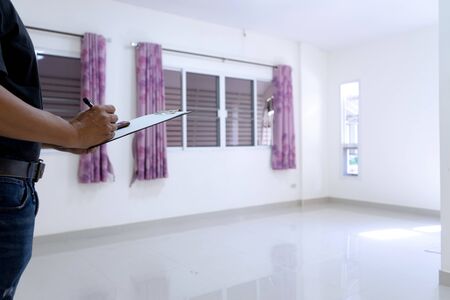 Empty house and blank room, the repairman checking list for looking the point to repair or prepare the home to the buyer.の写真素材